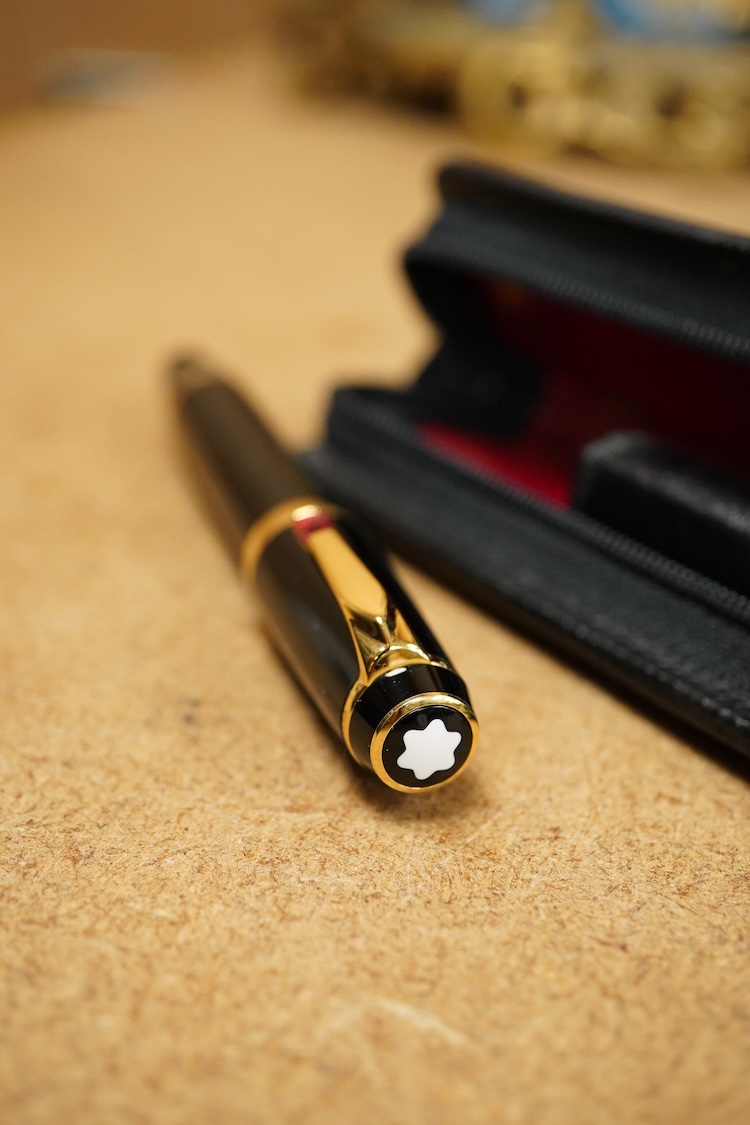 A leather cased Mont Blanc pen with retractable nib and decorative jewelled clip, 11cm long